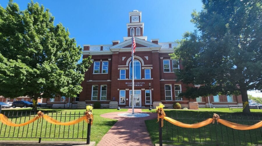 Bullitt County Courthouse front exterior with orange ribbon decorating the iron gate